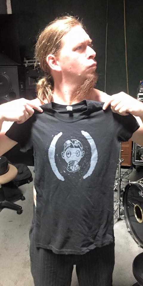 Black t-shirt with gas mask between giant paretheses printed in white